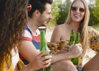Group of friends spending nice time with beer bottles