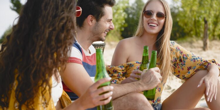 Group of friends spending nice time with beer bottles